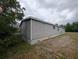 Home exterior with light gray siding, showcasing its clean design at 15591 Charmwood Dr, Hudson, FL 34667