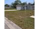 Charming single-story home featuring a garage, well-maintained lawn, and pleasant landscaping at 15591 Charmwood Dr, Hudson, FL 34667