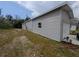 Well-maintained single-Gathering home with a grey facade, attached garage, and side yard at 15591 Charmwood Dr, Hudson, FL 34667