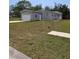 Charming single-story home featuring a garage, well-maintained lawn, and pleasant landscaping at 15591 Charmwood Dr, Hudson, FL 34667