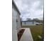 Exterior shot of a home with gray siding and a concrete walkway at 15591 Charmwood Dr, Hudson, FL 34667