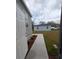 Exterior shot of a home with gray siding and a concrete walkway at 15591 Charmwood Dr, Hudson, FL 34667