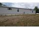 Exterior side view of home showing light gray vinyl siding at 15591 Charmwood Dr, Hudson, FL 34667