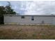 Exterior side view of home showing light gray vinyl siding at 15591 Charmwood Dr, Hudson, FL 34667