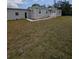 Exterior elevation of a home with gray siding, a manicured lawn, and a charming front porch at 15591 Charmwood Dr, Hudson, FL 34667