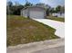 Detached garage with a concrete driveway, perfect for extra storage and parking at 15591 Charmwood Dr, Hudson, FL 34667
