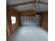 Interior view of the garage with wood framing and a white garage door at 15591 Charmwood Dr, Hudson, FL 34667