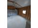 Interior view of the garage with wood framing and a white garage door at 15591 Charmwood Dr, Hudson, FL 34667