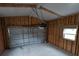 Interior view of the garage with wood framing and a white garage door at 15591 Charmwood Dr, Hudson, FL 34667