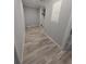 Hallway with wood-look flooring and neutral gray paint throughout the home at 15591 Charmwood Dr, Hudson, FL 34667