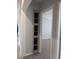 Hallway with bedroom and built-in shelves for storage and display at 15591 Charmwood Dr, Hudson, FL 34667