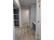 Entry hallway with built-in shelves and desk area and wood-look flooring at 15591 Charmwood Dr, Hudson, FL 34667