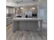 Well-equipped kitchen with a gray island, stainless steel appliances, and modern lighting at 15591 Charmwood Dr, Hudson, FL 34667