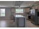 Spacious kitchen featuring stainless steel appliances, an island, and tiled backsplash at 15591 Charmwood Dr, Hudson, FL 34667