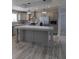 Open kitchen featuring gray cabinets, granite counters, and stainless appliances at 15591 Charmwood Dr, Hudson, FL 34667