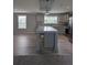 Modern kitchen with gray cabinets, stainless steel appliances, granite counters, and large kitchen island at 15591 Charmwood Dr, Hudson, FL 34667