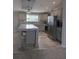 Modern kitchen with gray cabinets, stainless steel appliances, granite counters, and large kitchen island at 15591 Charmwood Dr, Hudson, FL 34667