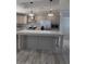 Modern kitchen featuring stainless steel refrigerator, built-in microwave, and large kitchen island at 15591 Charmwood Dr, Hudson, FL 34667