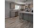 Modern kitchen with gray cabinets, stainless steel appliances, granite counters, and stainless steel sink at 15591 Charmwood Dr, Hudson, FL 34667