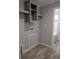 Functional laundry area with built-in shelving and washer/dryer hookups at 15591 Charmwood Dr, Hudson, FL 34667