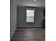 Bright living room showcasing a window with blinds and hardwood floors at 15591 Charmwood Dr, Hudson, FL 34667