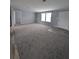Spacious living room with gray carpet and a large window providing natural light at 15591 Charmwood Dr, Hudson, FL 34667