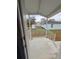 View of the covered front porch area with white railings, and view of the front yard at 15591 Charmwood Dr, Hudson, FL 34667