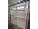 Walk-in shower featuring glass doors, built-in bench, and white tile at 15591 Charmwood Dr, Hudson, FL 34667