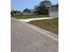 Wide concrete driveway leading to a spacious two-car garage, providing ample parking at 15591 Charmwood Dr, Hudson, FL 34667