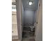 Enclosed toilet room next to shower with white toilet and wood-look flooring at 15591 Charmwood Dr, Hudson, FL 34667