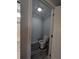 Enclosed toilet room featuring white toilet and wood-look flooring at 15591 Charmwood Dr, Hudson, FL 34667