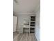 Vanity with drawers, shelving, mirror, and wood-look flooring at 15591 Charmwood Dr, Hudson, FL 34667