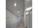 This walk-in closet features wire shelving and wood-look tile floor at 15591 Charmwood Dr, Hudson, FL 34667