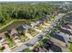 Scenic aerial view of the property with wooded area, pond, and community park at 1669 Ludington Ave, Wesley Chapel, FL 33543