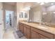 Double sink vanity with granite countertop, walk-in shower, and open closet at 1669 Ludington Ave, Wesley Chapel, FL 33543
