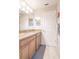 Bathroom featuring granite countertops, wood cabinets, and stylish tiled floors at 1669 Ludington Ave, Wesley Chapel, FL 33543