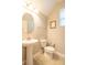 Neutral toned half-bath featuring pedestal sink and tiled floors at 1669 Ludington Ave, Wesley Chapel, FL 33543