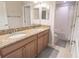 Well-lit bathroom featuring a double sink vanity with granite countertops and a shower-tub combo at 1669 Ludington Ave, Wesley Chapel, FL 33543