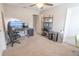 Bedroom featuring a ceiling fan, an ergonomic chair, and a computer desk with dual monitors at 1669 Ludington Ave, Wesley Chapel, FL 33543
