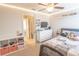 Well lit bedroom featuring a ceiling fan, shelf decorations, and closet access at 1669 Ludington Ave, Wesley Chapel, FL 33543