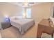 Bedroom with a plush queen bed, bedside tables with lamps, and a wood dresser at 1669 Ludington Ave, Wesley Chapel, FL 33543