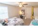 Comfortable bedroom includes a ceiling fan, window, and a stylish workstation at 1669 Ludington Ave, Wesley Chapel, FL 33543