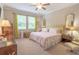 Bedroom features large windows, ceiling fan, and an accent headboard at 1669 Ludington Ave, Wesley Chapel, FL 33543
