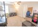Bedroom with a ceiling fan, white board, and a computer setup featuring a gaming chair at 1669 Ludington Ave, Wesley Chapel, FL 33543