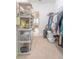 Carpeted walk-in closet with plastic shelving and a view of the bedroom at 1669 Ludington Ave, Wesley Chapel, FL 33543