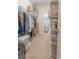 Walk-in closet with built-in shelving and hanging storage for organization at 1669 Ludington Ave, Wesley Chapel, FL 33543