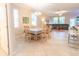 Dining room with a table and chairs, adjacent to the open kitchen and living area at 1669 Ludington Ave, Wesley Chapel, FL 33543