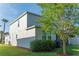 This home features a well-maintained lawn, a trimmed bush, and an outdoor grill for backyard entertaining at 1669 Ludington Ave, Wesley Chapel, FL 33543