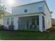 View of the home's screened-in patio and lush lawn; perfect for outdoor entertaining and enjoying the backyard at 1669 Ludington Ave, Wesley Chapel, FL 33543