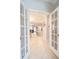 Welcoming foyer with neutral tile flooring and clear view to the kitchen and living room at 1669 Ludington Ave, Wesley Chapel, FL 33543
